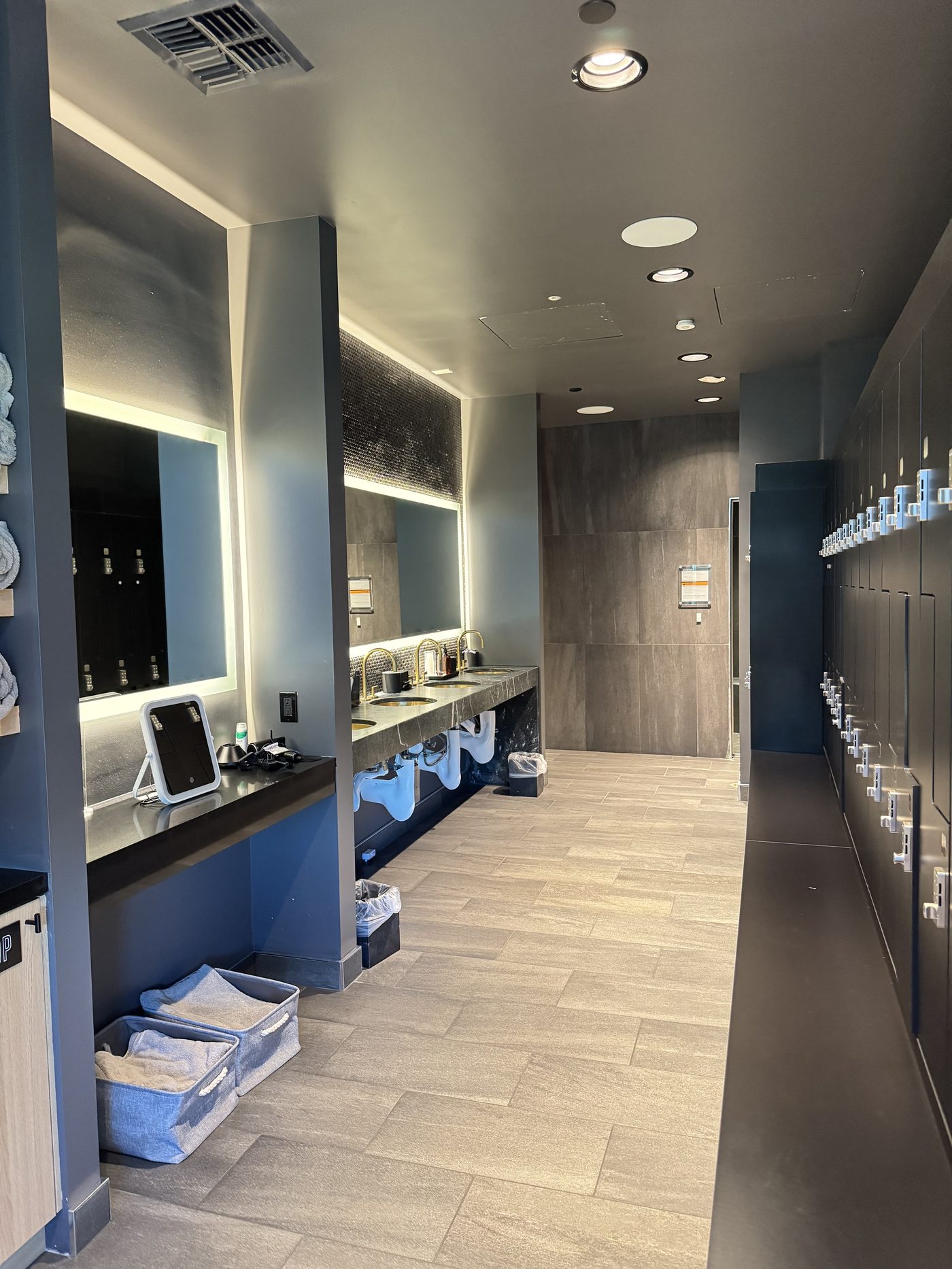 Locker room at Morning Wellness Club with vanity, lighting, and private lockers