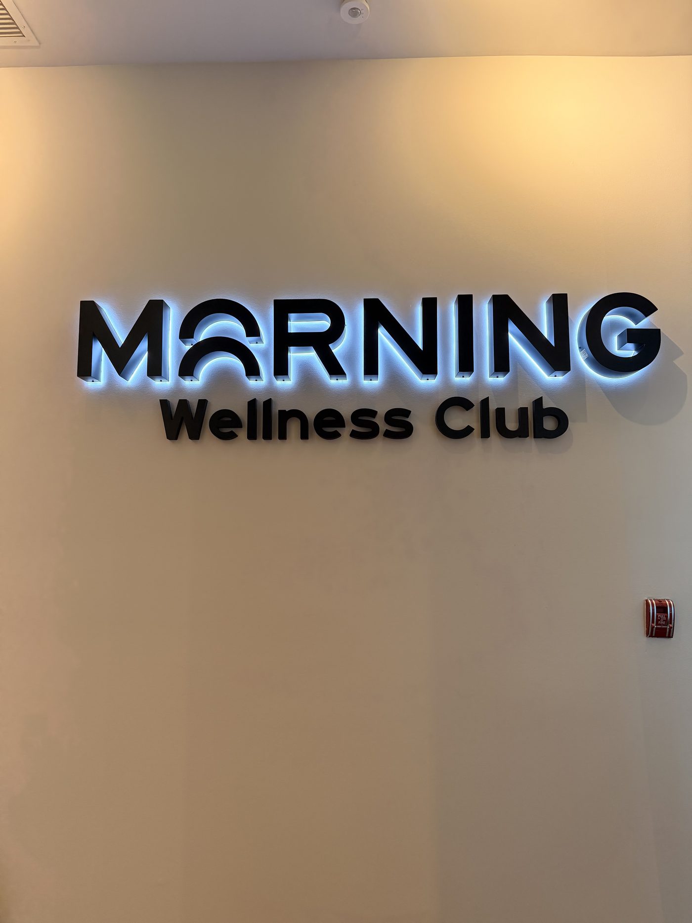 Morning Wellness Club backlit signage at the facility entrance
